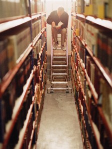 Man Reading Book in Archive Facility © Helen King